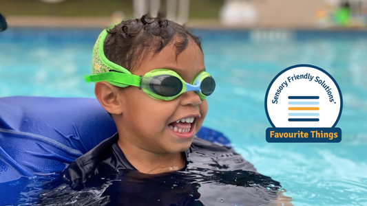 boy in green frogglez goggles with Sensory friendly solutions logo