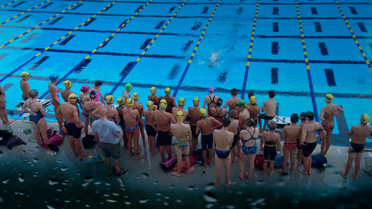 Swim team practice at swimming pool wearing Frogglez swim goggles. Frogglez comfortable neoprene strap won't pull hair. Best swim goggles for boys. Best swim goggles for girls.