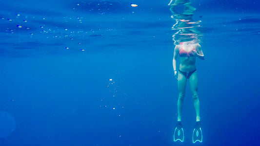 Teen girl snorkeling in ocean