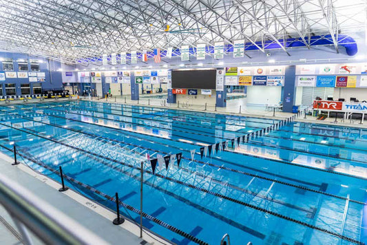 Olympic swimming pool with ten lanes. Swim meet distance in meters, swim meet measured in yards. swimming goggles. best goggles for kids in swim lessons
