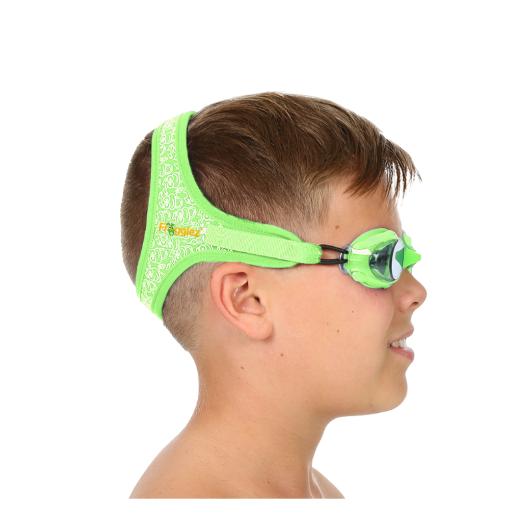 Green Frogz repeating patterned swimming goggles on white background