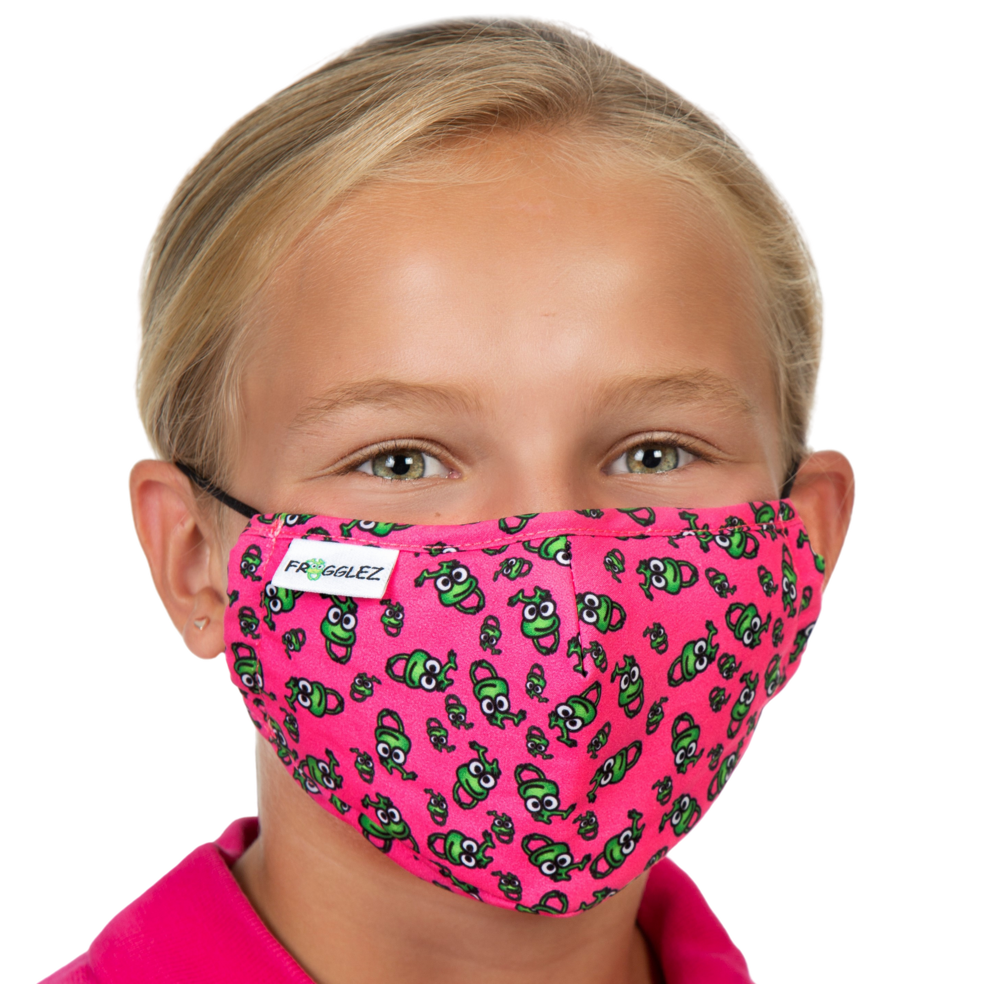 Young girl wearing pink shirt wears a pink face mask with Frogglez frog print.