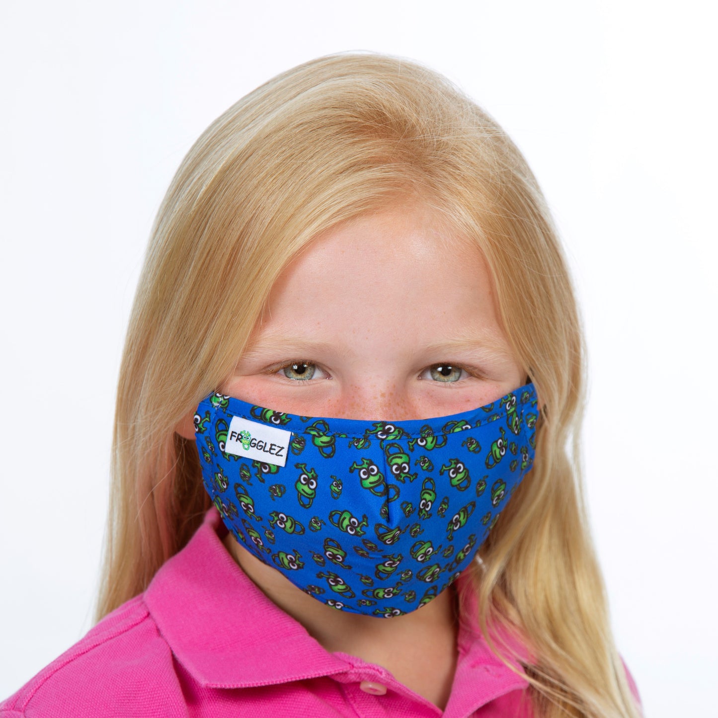 young girl wearing pink shirt and blue cloth face mask with frog print